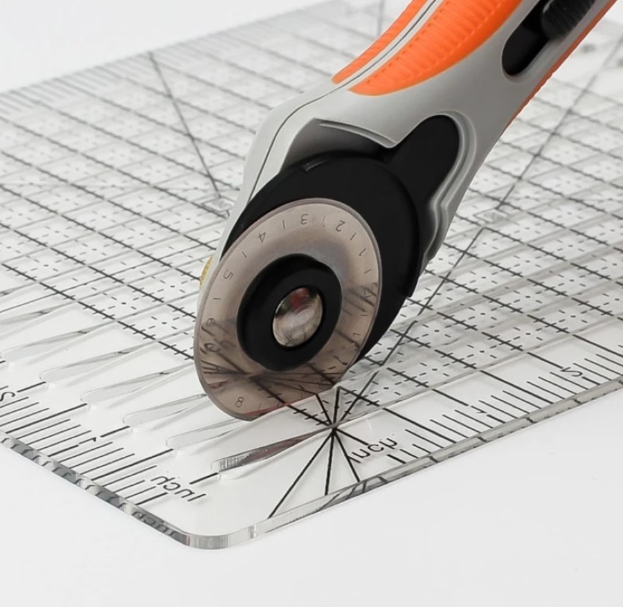 specialty cutting ruler for strip cutting fabric with a rotary cutter