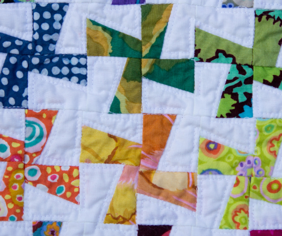 pieced bright pinwheels on a quilt